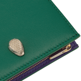 Serpenti Forever compact wallet in jade green Metropolitan calf leather with amethyst purple nappa leather interior and inner nappa leather details in shades of amethyst purple, lavender and sheer amethyst lilac. Captivating snakehead press-stud closure in light gold-plated brass embellished with red enamel eyes. SEA-COMPACTWLT image 4