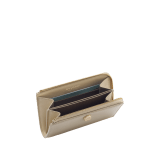 Serpenti Forever zipped card holder in bright travertine ivory calf leather with moonrock light grey and aquamarine nappa leather interior. Captivating snakehead rivet in light gold-plated brass embellished with red enamel eyes. SEA-MC-CCHOLDS image 2