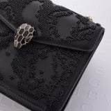 Serpenti Forever small crossbody bag in black Snake Invaders Metropolitan calf leather with a hand-sewn black glass beads embroidery and black nappa leather lining. Captivating snakehead magnetic closure in light gold-plated brass embellished with matte and shiny black enamel scales, and black onyx eyes. 292275 image 6
