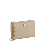 Serpenti Forever zipped card holder in bright travertine ivory calf leather with moonrock light grey and aquamarine nappa leather interior. Captivating snakehead rivet in light gold-plated brass embellished with red enamel eyes. SEA-MC-CCHOLDS image 1