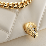 "Serpenti Cabochon" small maxi chain crossbody bag in soft quilted Ivory Opal white calf leather, with a maxi graphic motif, and black nappa leather internal lining. New Serpenti head closure in gold plated brass, finished with small white mother-of pearl scales in the middle and red enamel eyes. 1165-NSMb image 5
