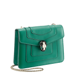 Serpenti Forever small crossbody bag in emerald green calf leather with amethyst purple grosgrain lining. Captivating snakehead closure in light gold-plated brass embellished with black and white agate enamel scales and green malachite eyes. 422-CLa image 2