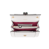 Serpenti Forever small crossbody bag in emerald green calf leather with amethyst purple grosgrain lining. Captivating snakehead closure in light gold-plated brass embellished with black and white agate enamel scales and green malachite eyes. 1082-CLa image 3