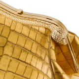 Serpentine medium pouch in antique gold soft metallic crocodile skin with 24 kt gold treatment and emerald green nappa leather lining. Captivating snake-shaped frame in gold-plated brass including 3 µ of 24 kt gold, embellished with engraved scales and red enamel eyes on one side and antique gold soft metallic crocodile insert on the other, and press-button closure. Exclusive Bulgari 50th anniversary in the US Edition. 292590 image 5