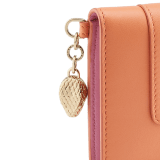 Serpenti Forever folded card holder in coral carnelian orange calf leather with flamingo quartz pink nappa leather interior. Captivating light gold-plated brass snakehead charm with red enamel eyes, and press-stud closure. SEA-CC-HOLDER-FOLD-Cla image 4