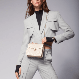 Serpenti Forever crossbody bag in ivory opal laser-cut calf leather with caramel topaz beige nappa leather lining. Captivating snakehead closure in light gold-plated brass embellished with matte and shiny ivory opal enamel scales and black onyx eyes. 422-LCL image 7