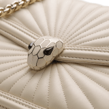 Serpenti Diamond Blast small shoulder bag in ivory opal Sunshine quilted nappa leather with black nappa leather lining. Captivating snakehead closure in light gold-plated brass embellished with matt and shiny ivory opal enamel scales and black onyx eyes. 922-SQ image 4