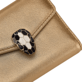 Serpenti Forever slim compact wallet in emerald green calf leather with black nappa leather interior. Captivating snakehead press button closure in light gold-plated brass embellished with black and white agate enamel scales and black onyx eyes. SEA-SLIMCOMPACT-Clb image 4