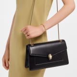 Serpenti Forever medium shoulder bag in black calf leather with black nappa leather lining. Captivating snakehead magnetic closure in light gold-plated brass embellished with beige noisette enamel and light gold-plated brass scales, and black onyx eyes. SEA-001-1344M image 2