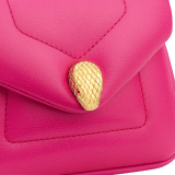 Serpenti Reverse micro top handle bag in truly tourmaline fuchsia Metropolitan calf leather with royal ruby red nappa leather lining. Captivating snakehead magnetic closure in gold-plated brass embellished with red enamel eyes. SRV-NANOREVERSE-MCL image 4