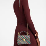Serpenti Forever mini top handle bag with multicoloured Calla Crystals pattern and black nappa leather lining. Captivating snakehead magnetic closure in gold-finished brass embellished with diamond-cut engraving on the scales and black onyx eyes. SEA-001-1283XS-crys image 1