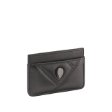 Serpenti Cabochon card holder in black calf leather with maxi matelassé pattern. Captivating snakehead rivet in gold-plated brass embellished with red enamel eyes. SCB-CCHOLDER image 1