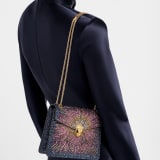 Serpenti Forever Day-to-Night small shoulder bag in multigradient Fireworks Crystals with black nappa leather lining. Captivating snakehead magnetic closure in gold-plated brass embellished with diamond-cut engraving on the scales, and black onyx eyes. SEA-001-1281S-fireworks image 1
