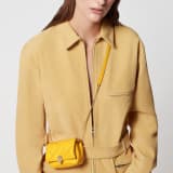 Serpenti Cabochon micro bag in gold calf leather with a maxi matelassé pattern and black nappa leather lining. Captivating snakehead closure in light gold-plated brass embellished with red enamel eyes. SCB-NANOCABOCHONb image 5