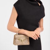 Serpenti Forever mini top handle bag in multigradient Fireworks Crystals with black nappa leather lining. Captivating snakehead magnetic closure in gold-plated brass embellished with diamond-cut engraving on the scales, and black onyx eyes. SEA-001-1283XS-fireworks image 1