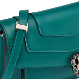 Serpenti Forever East-West small shoulder bag in black calf leather with emerald green grosgrain lining. Captivating snakehead magnetic closure in light gold-plated brass embellished with black and white agate enamel scales, and green malachite eyes. 1237-CL image 5