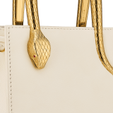 Serpentine mini tote bag in ivory opal Metropolitan calf leather with black nappa leather lining. Captivating snake body-shaped handles in gold-plated brass embellished with engraved scales and red enamel eyes. SRN-1223-CL image 5
