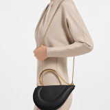 Serpenti Cuore 1968 medium top handle bag in black calf leather with black nappa leather lining. Captivating snake body-shaped top handle in gold-plated brass embellished with engraved scales and zirconia eyes; press-button closure. 294670 image 1