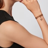 Serpenti Forever bracelet in deep gold Striated braided calf leather and light gold-plated brass chain with magnetic clasp closure. Captivating snakehead charm with beige and transparent enamel scales, and black enamel eyes. SERP-BRAIDCHAIN-SCL-DG image 1