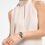 Serpenti Forever soft bangle bracelet in emerald green calf leather. Captivating contraire snakehead décor in light gold-plated brass embellished with black and white agate enamel scales and emerald green enamel eyes. SERP-SOFT-CONTR image 1