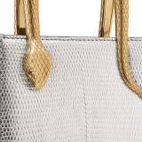 Serpentine mini tote bag in beetroot spinel fuchsia degradé lizard skin with azalea quartz pink nappa leather lining. Captivating snake body-shaped handles in light gold-plated brass embellished with engraved scales and red enamel eyes. SRN-1223-LD image 5