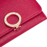 Business card holder in ruby red bright grain calf leather, desert quartz nappa and fuxia nappa lining. Iconic brass light gold plated clip featuring the BVLGARI BVLGARI motif. 579-BC-HOLDER-BGCLa image 4