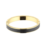 "BVLGARI BVLGARI" bangle bracelet in gold plated brass with a Moon Silver black metallic karung skin insert and a BVLGARI logo hinge closure. Logo engraving along the edges of both sides of the bracelet and in the inner part. HINGELOGOBRCLT-MK-B image 1