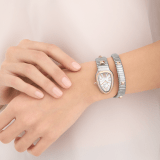 Serpenti Tubogas Studs Capsule single-spiral watch in stainless steel with 18 kt yellow gold diamond-set bezel, 18 kt yellow gold studs on the bracelet, and mother-of-pearl dial. Water-resistant up to 30 metres. Serpenti-Tubogas-Studs-Capsule image 2
