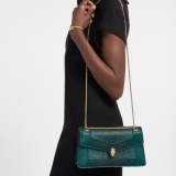 Serpenti Forever medium shoulder bag in forest emerald shiny karung with black nappa leather lining. Captivating snakehead magnetic closure in gold-plated brass embellished with forest emerald enamel and gold-plated brass scales, and black onyx eyes. 295625 image 1