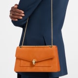 Serpenti Forever medium shoulder bag in black calf leather with black nappa leather lining. Captivating snakehead magnetic closure in light gold-plated brass embellished with beige noisette enamel and light gold-plated brass scales, and black onyx eyes. SEA-001-1344M image 1