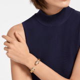 Serpenti Forever bangle bracelet in gold-finished brass with soft gold nappa leather inserts. Captivating contraire snakehead motif in gold-finished brass embellished with pavé-set white zirconia stones and black enamel eyes. BRACLT-SP-CONTR-softnappa image 1