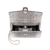 “Serpenti Forever” crossbody bag in white agate metallic karung skin. Iconic snakehead closure in light gold plated brass enriched with black and white agate enamel and black onyx eyes. 422-MK image 4