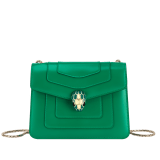 Serpenti Forever small crossbody bag in vivid emerald green calf leather with beet amethyst fuchsia grosgrain lining. Captivating snakehead magnetic closure in light gold-plated brass embellished with bright forest emerald green enamel and light gold-plated brass scales, and black onyx eyes. 422-CLe image 1