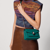 Serpenti Forever small crossbody bag in emerald green calf leather with amethyst purple grosgrain lining. Captivating snakehead closure in light gold-plated brass embellished with black and white agate enamel scales and green malachite eyes. 1082-CLa image 7