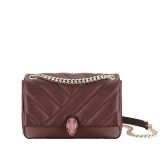 "Serpenti Cabochon" shoulder bag in soft quilted Oxblood bordeaux grainy calf leather, with a graphic motif, and Berry Tourmaline fuchsia nappa leather internal lining. Tempting snakehead closure in light gold plated brass enriched with dégradé Oxblood bordeaux enamel from ultrabright to bright, with black onyx eyes. SC-UCL-DG image 1