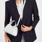 Bvlgari Roma mini top handle bag in flash diamond white Metropolitan calf leather with milky opal nappa leather lining. Iconic metal detail in palladium-plated brass engraved with the Bvlgari logo, and magnetic press-button closure. BVR-001-1310XS-CALF image 2