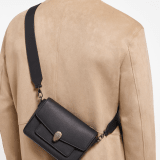 Serpenti Forever small unisex crossbody bag in matt black calf leather with black nappa leather lining and decorative chain. Captivating snakehead closure in dark ruthenium-plated brass embellished with red enamel eyes. 293022 image 2