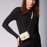 Serpenti Cabochon micro bag in ivory opal calf leather with a maxi matelassé pattern and black nappa leather lining. Captivating snakehead closure in gold-plated brass embellished with red enamel eyes. SCB-NANOCABOCHONa image 5