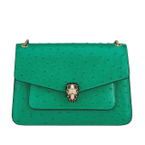 Serpenti Forever medium shoulder bag in vivid emerald green shiny ostrich skin with emerald green nappa leather lining. Captivating snakehead magnetic closure in light gold-plated brass embellished with black enamel and light gold-plated brass scales and black onyx eyes. 293263 image 1
