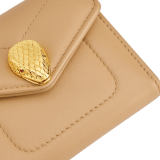 Serpenti Reverse compact wallet in Sahara amber light brown quilted Metropolitan calf leather with taffy quartz pink Metropolitan calf leather interior. Captivating snakehead press button closure in gold-plated brass embellished with red enamel eyes. SRV-COMPACTWLT image 4