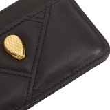 Serpenti Cabochon card holder in black calf leather with maxi matelassé pattern. Captivating snakehead rivet in gold-plated brass embellished with red enamel eyes. SCB-CCHOLDER image 4