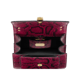 Serpenti Forever Maxi Chain small crossbody bag in anemone spinel pinkish red soft shiny python skin with black nappa leather lining. Captivating magnetic snakehead closure in gold-plated brass embellished with black onyx scales and red enamel eyes. 1134-SSP image 4