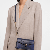 Serpenti Forever chain pochette in milky opal metallic karung with milky opal nappa leather lining. Captivating snakehead magnetic closure in gold-plated brass embellished with foggy opal enamel and black onyx eyes. SEA-CH-POCHETTE-R-kar image 1