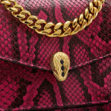 Serpenti Forever Maxi Chain small crossbody bag in soft, shiny anemone spinel pinkish red python skin with black nappa leather lining. Captivating magnetic snakehead closure in gold-plated brass embellished with black onyx scales and red enamel eyes. 1134-SSP image 5