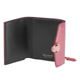 "Serpenti Forever" slim compact wallet in Blush Quartz pink calf leather with a varnished and pearled effect and black calf leather. Tempting gold plated brass snakehead stud closure, finished with matte Blush Quartz pink enamel, and black enamel eyes. SEA-SLIMCOMPACT-VCLa image 2
