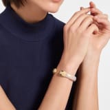 Serpenti Forever bangle bracelet in gold-finished brass with rose gold space lamb leather inserts. Captivating contraire snakehead motif in gold-finished brass embellished with rose gold enamel, gold-finished brass scales and black enamel eyes. BRACLT-SP-CONTR-spacelamb image 1