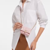 Serpenti Cabochon micro bag in light pink Pure karung with a maxi matelassé pattern and light pink nappa leather lining. The bag features a captivating magnetic snakehead closure in light gold-plated brass embellished with red enamel eyes. 294186 image 1