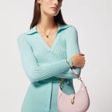 Serpenti Ellipse small crossbody bag in Urban grain and smooth ivory opal calf leather with flamingo quartz pink gros grain lining. Captivating snakehead closure in gold-plated brass embellished with black onyx scales and red enamel eyes. 1204-UCLa image 7