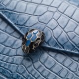 Serpenti Forever shoulder bag in Niagara sapphire blue Cloudy alligator skin with black nappa leather lining. Captivating snakehead closure in light gold-plated brass embellished with black enamel scales, blue jade scales in the centre and black onyx eyes. 1140HE-A image 4