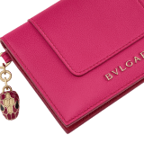 Serpenti Forever Special Resort Edition folded card holder in coral carnelian orange calf leather with beetroot spinel fuchsia nappa leather interior. Captivating snakehead charm embellished with red enamel eyes and a palm charm, both in light gold-plated brass, and press button closure. SEA-CC-HOLDER-FOLD-Clb image 4